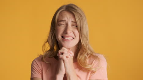 caucasian woman wishing for something on camera.