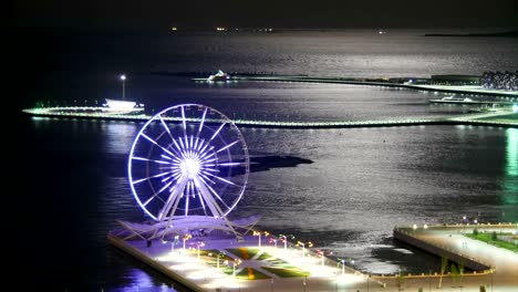 ferris wheel on the background of the sea and the lunar path. timelapse