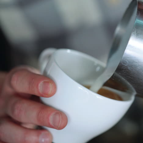 barista drawing the heart on the coffee. concept of services and beverages. sqare video