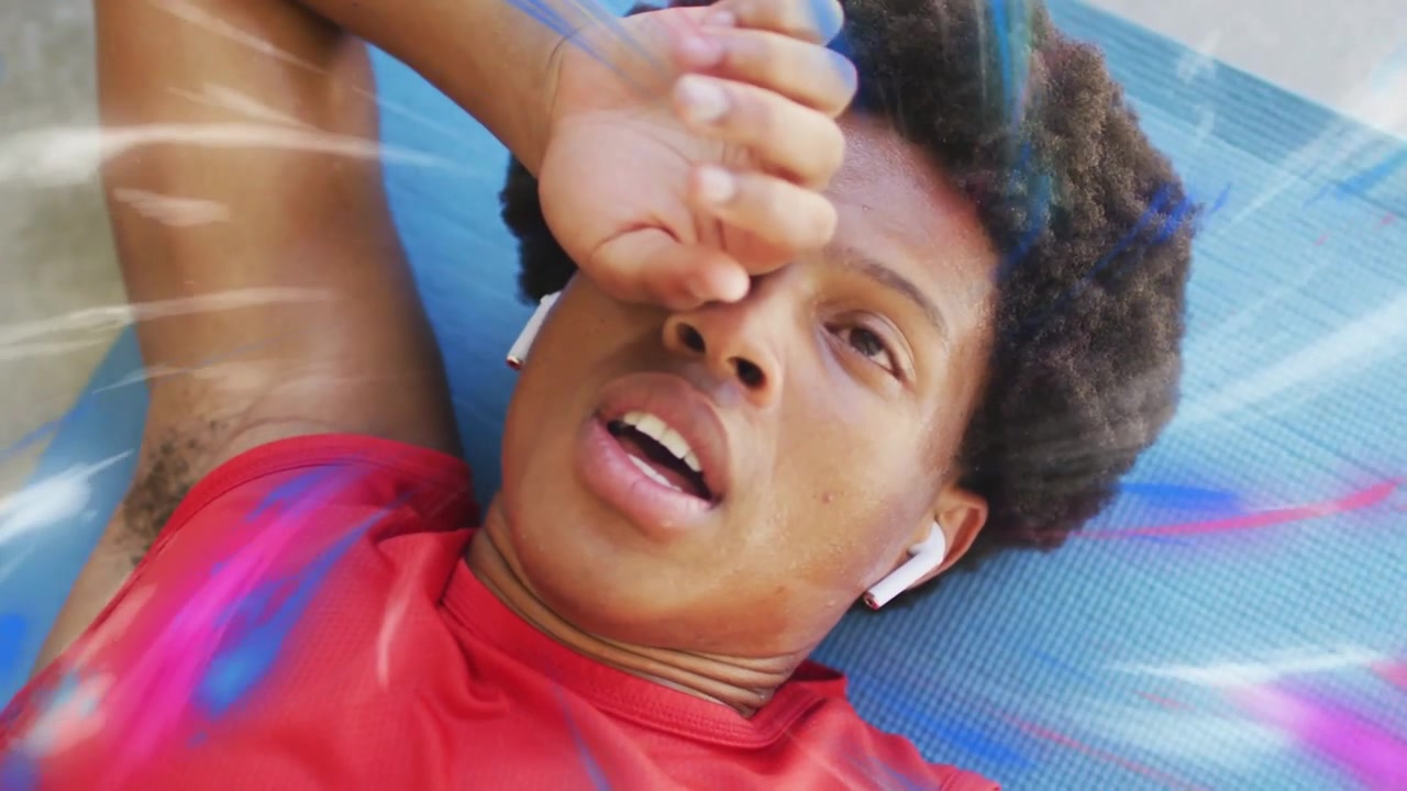 Exhausted Young Man Resting on Yoga Mat with Digital Effects