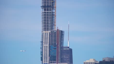 commercial airplane flying over the chicago skyline