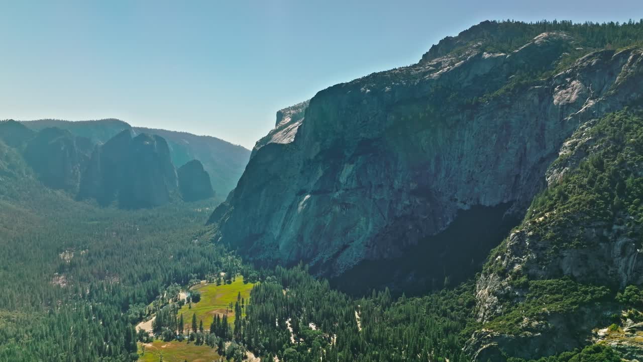 View of Yosemite Valley with evergreen forests visible in the background