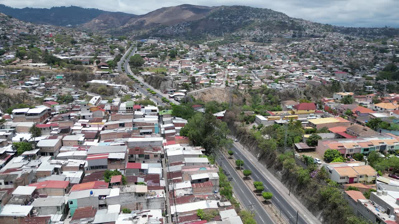 Aerial view of Tegucigalpa, Honduras, contrast between dense hillside housing and urban infrastructure