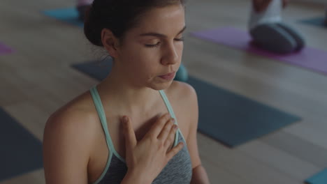 yoga class beautiful woman meditating practicing mindfulness breathing exercise enjoying spiritual practice in fitness studio at sunrise