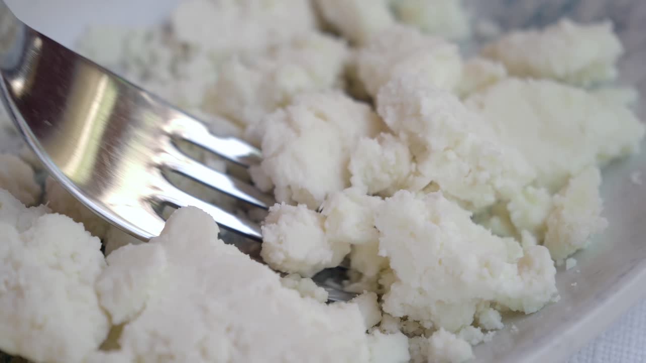 Crumbling White Cheese on a Plate