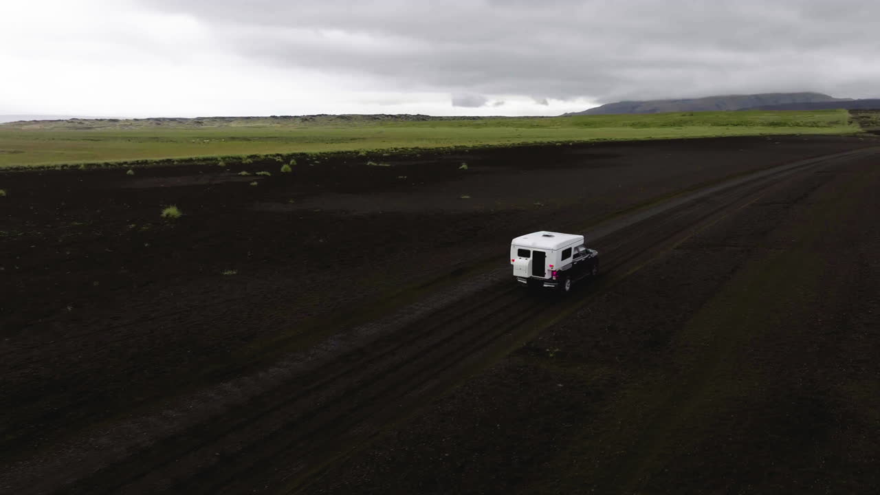 Aerial view circling a outlanding truck, driving in rough terrains of Iceland
