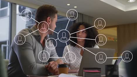 Animation-of-network-of-connections-with-icons-over-diverse-business-people-in-office