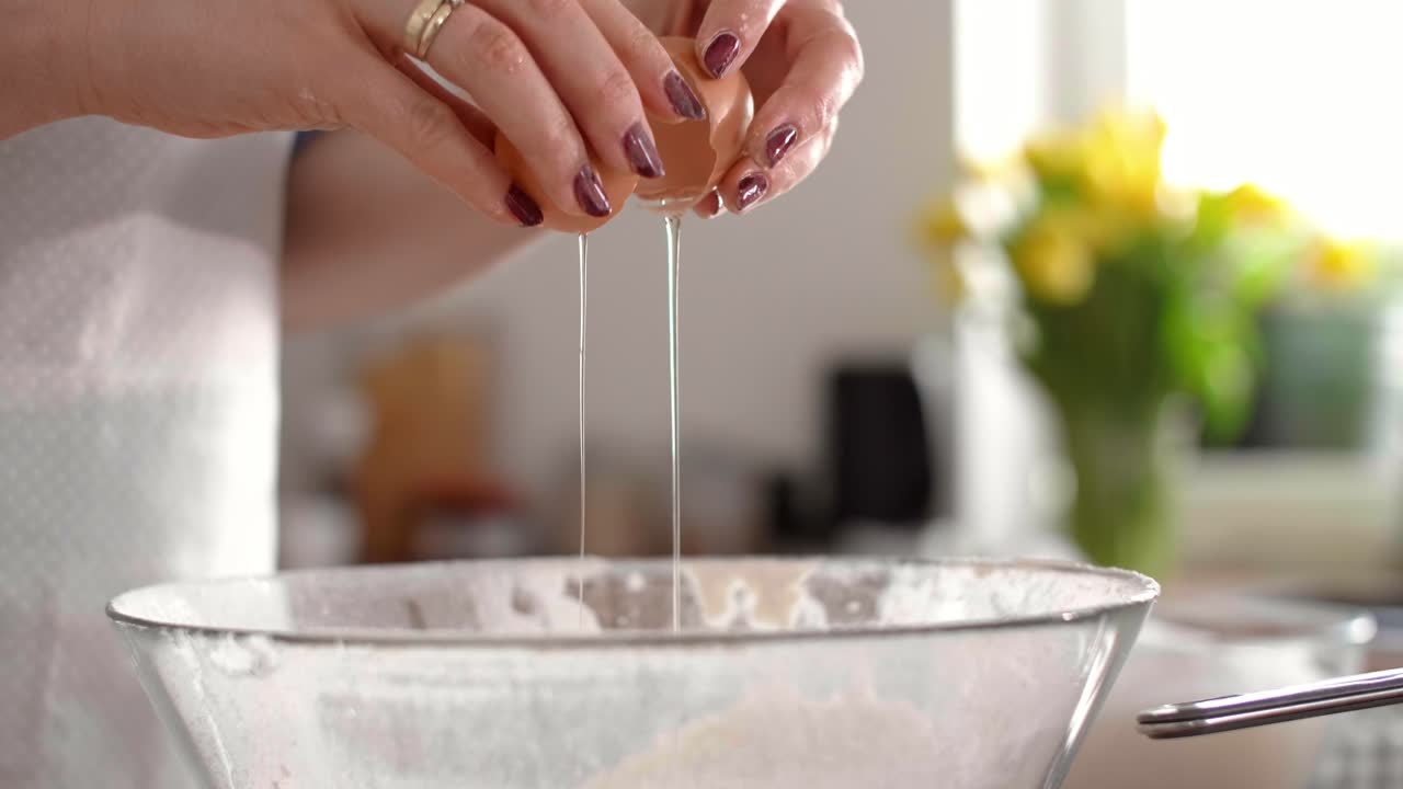Woman's hands breaking an egg