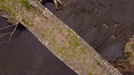 aerial-rotating-view-looking-down-at-cobbled-cromwells-bridge