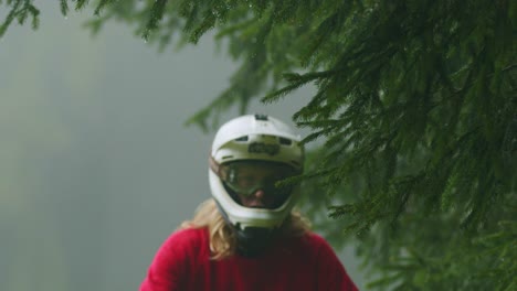 mountain biker hits tree branch with his helmet in slow motion