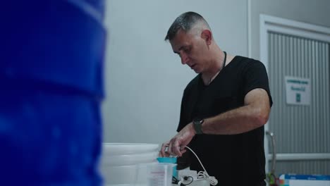 man working with water containers