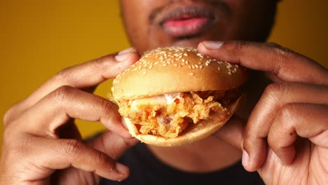 man eating a delicious chicken burger