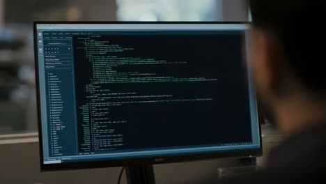 a person working on a computer displaying code