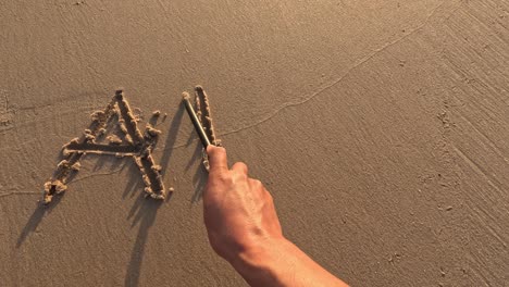 "abc" word is written on the beach sand