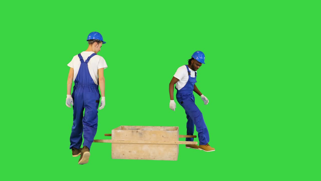 건설 노동자 들 은 초록색 스크린, 크로마 키 에 드 카로 를 들고 있는 동안 장소 를 바꾸고 있다