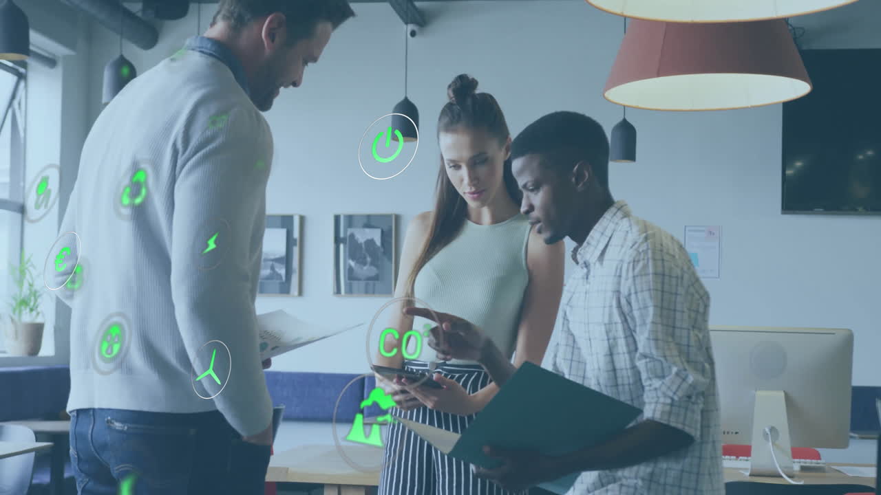 Animation of ecology icons over diverse colleagues discussing work in office