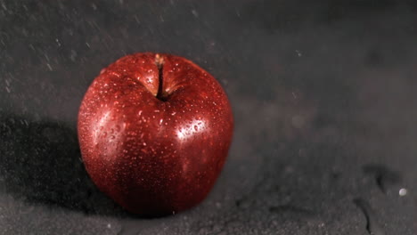 water sprayed on apple in super slow motion