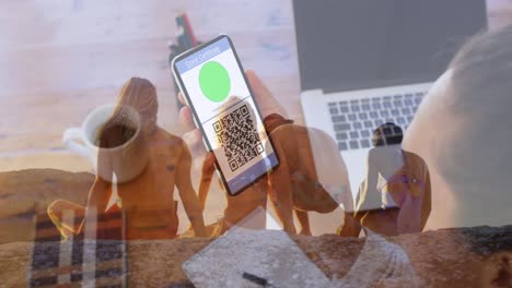 Animation-of-caucasian-woman-with-smartphone-with-covid-passport-over-people-on-beach