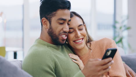 Happy-couple,-hug-and-love-with-cellphone-on-sofa