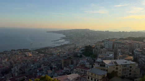 Dusk-view-of-coastal-city-lights-starting-to-glow---Naples,-Italy