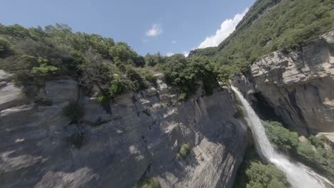 Spectacular-aerial-fpv-drone-shot-over-waterfall-ascending-and-descending