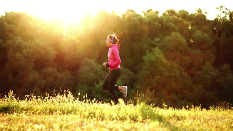 The-girl-runs-at-sunset-in-the-Park-along-the-pond-and-listening-to-music-in-headphones