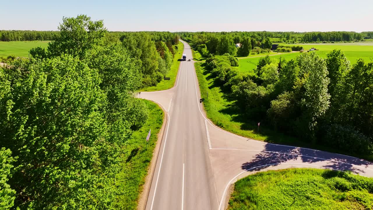 Bright green countryside and straight highway stretch across Latvia in spring