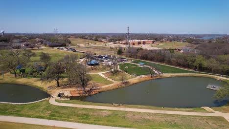 aerial footage approaching unity park in highland village texas and flying over two ponds