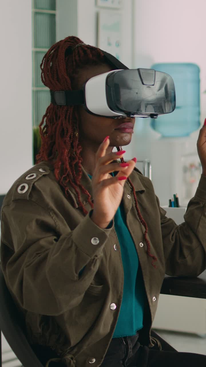 Vertical video: African american programmer working with vr glasses