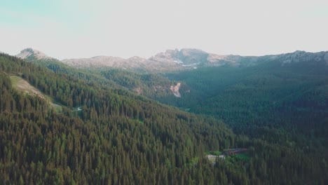 Forward-reveal-aerial-shot-in-the-Alps-with-a-peak-shown-in-the-background