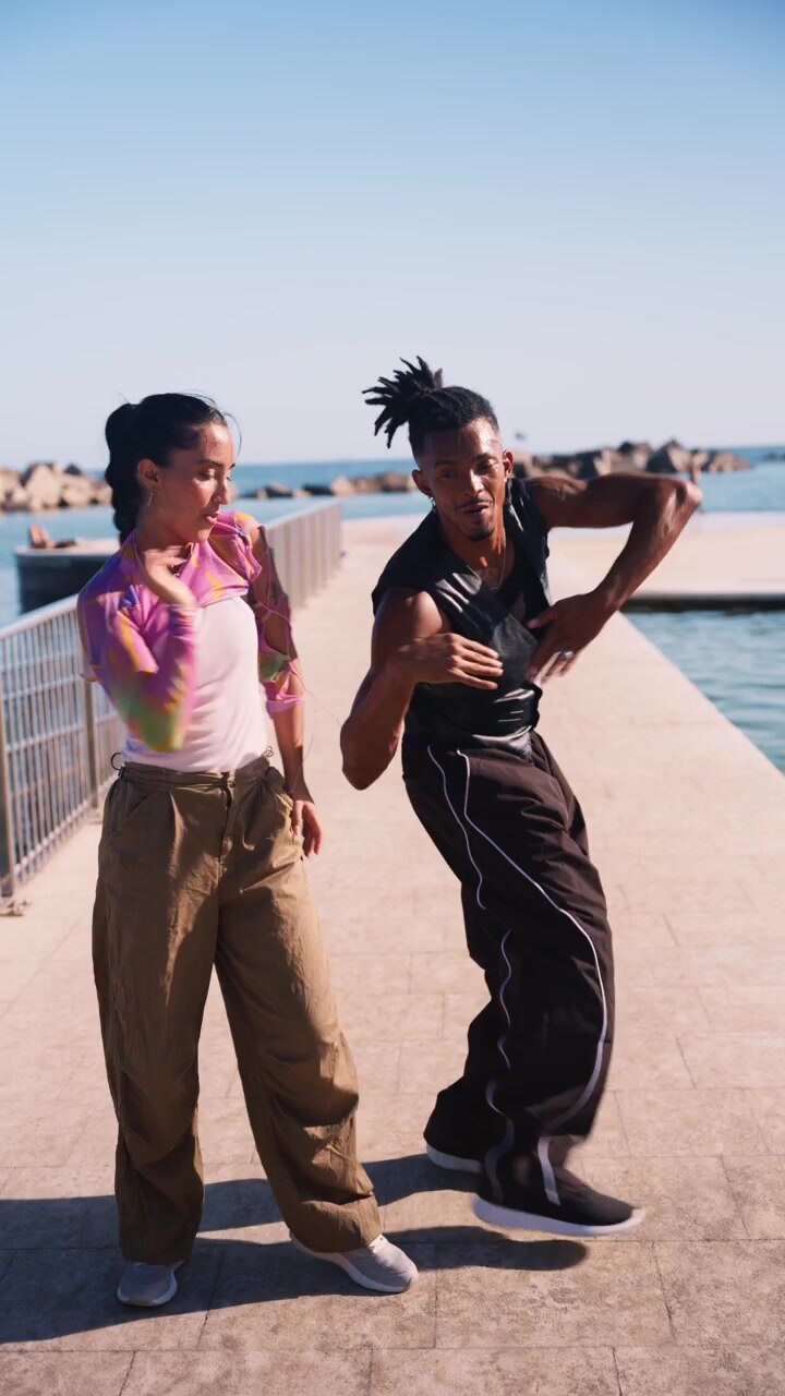 Young Couple Dancing Together on a Sunny Pier