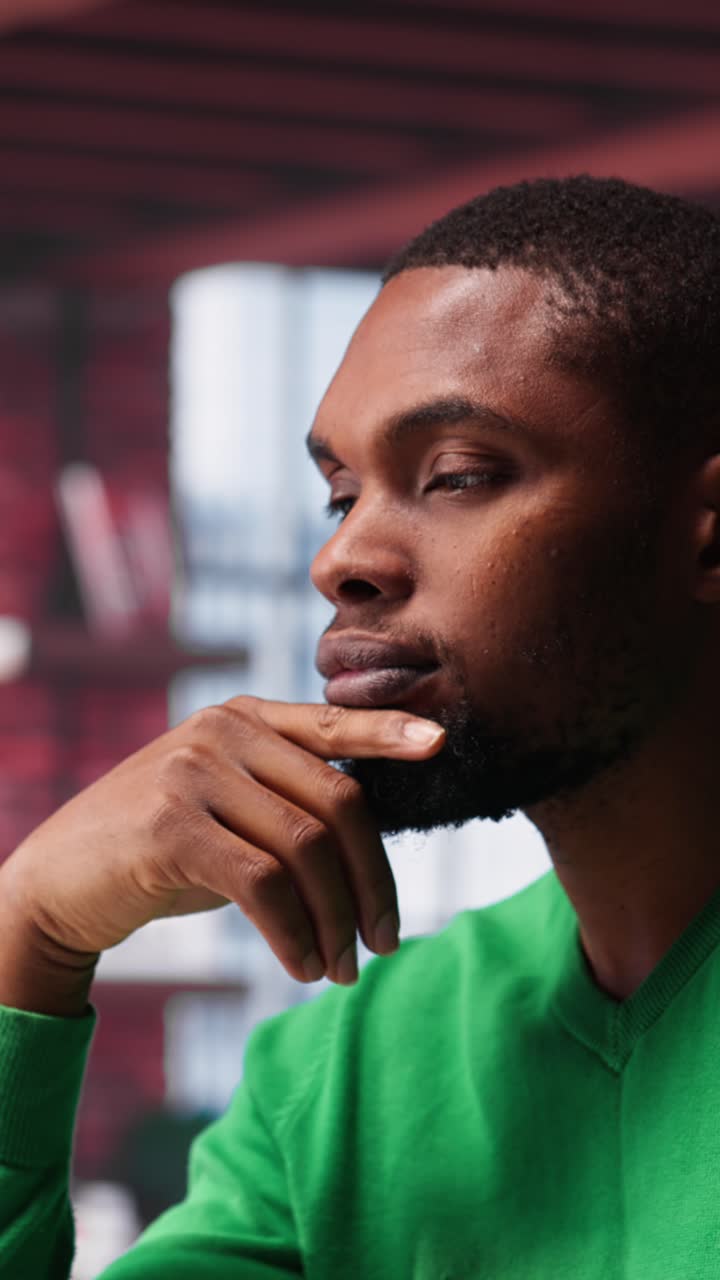 Vertical Video Black teleworker being pensive thinking about solutions to make more money