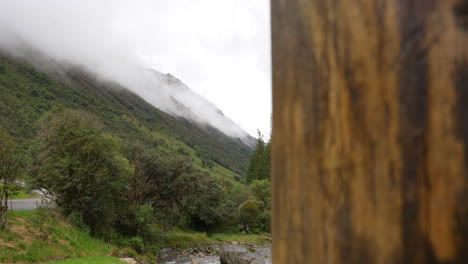 Stunning-mountain-covered-by-clouds-and-trees-all-around,-national-park