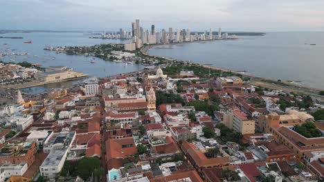 aerial of colonial old town of cartagena with the modern skyscrapers in the background, bolivar, colombia