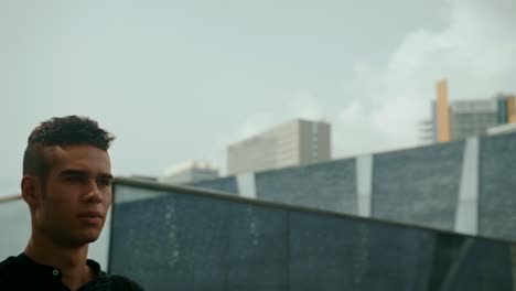 well-dressed entrepreneur businessman portrait of a young attractive trendy man wallking on a sunny morning day with a modern urban city background in slow motion