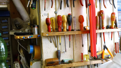 horologists workshop with clock repairing tools and equipments on wall