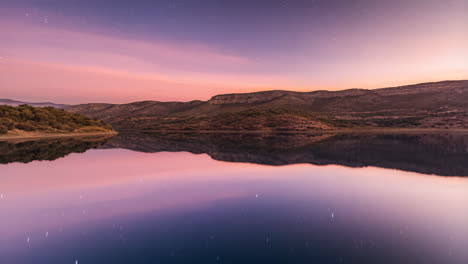 starry night sky reflected on a tranquil mountain lake