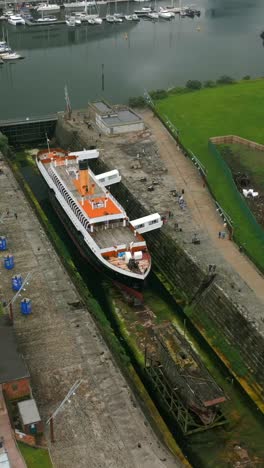 right-to-left travelling social ratio aerial video of the ss nomadic at titanic belfast in northern ireland, uk. produced in 1080x1920, 60fps and with rec709 color