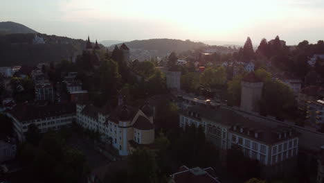 Aerial-view-flying-over-the-old-town-and-castle-towers-of-Lucern