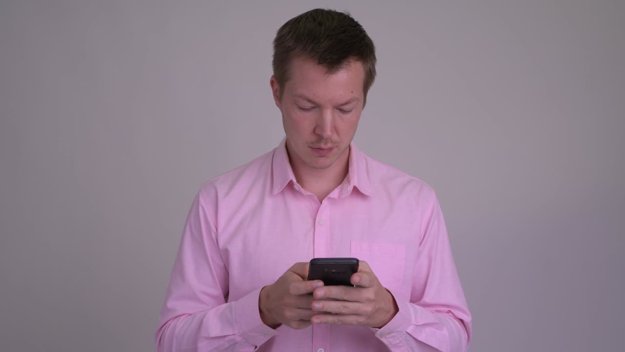 Young handsome businessman with pink shirt
