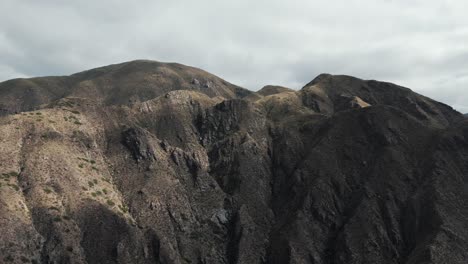 Aerial-View-of-Stunning-Large-Desert-Mountain-Face-Landscape