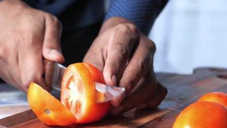 person chopping tomatoes