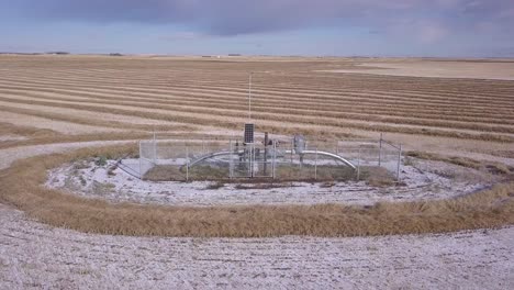 rotating aerial: natural gas pipeline monitor in wheat field, horizon