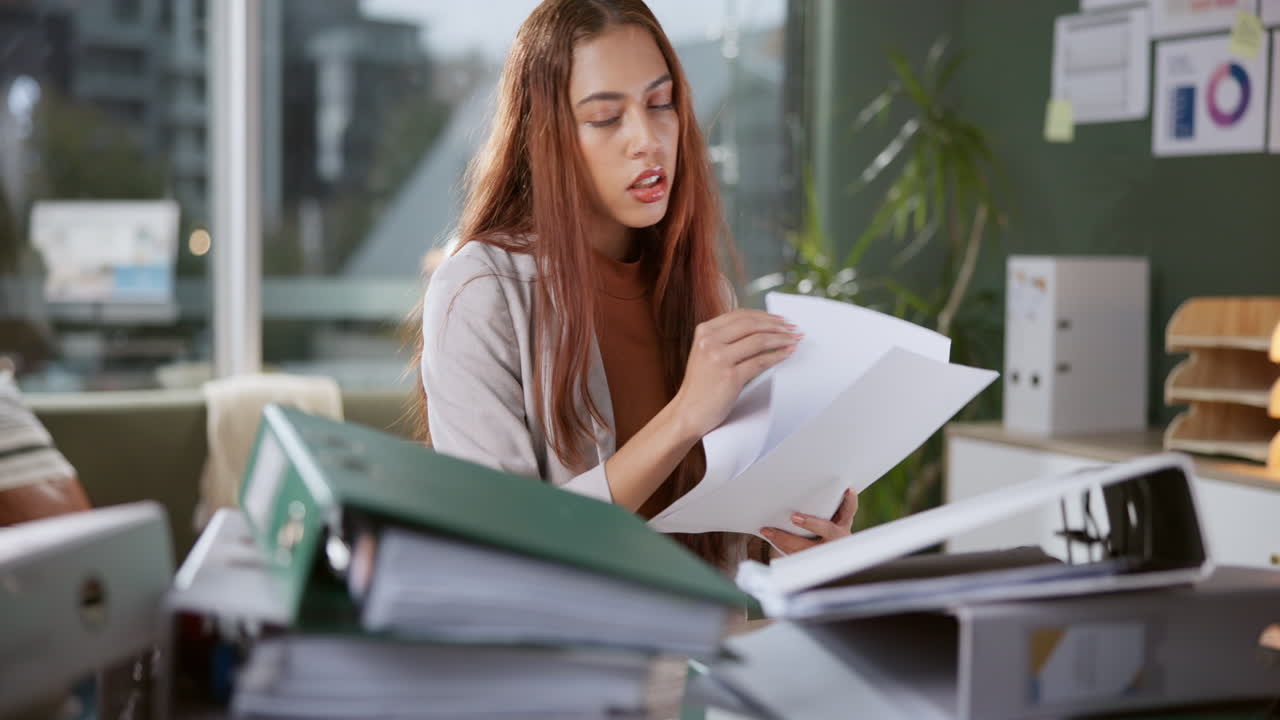 Businesswoman overwhelmed with paperwork at the office