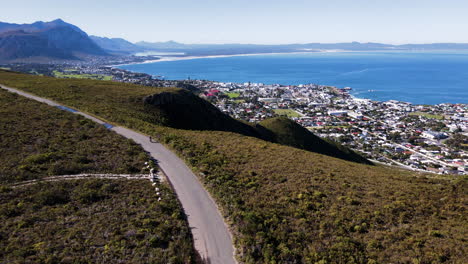 MTB-cyclist-on-Rotary-Drive-scenic-mountain-road-within-nature-reserve,-Hermanus