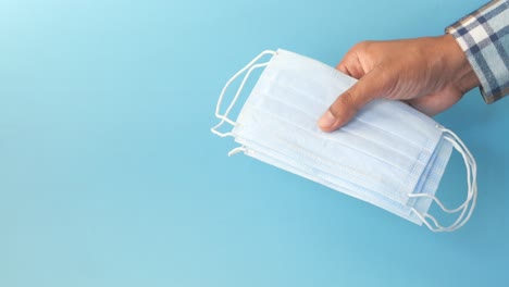 hand holding a stack of face masks