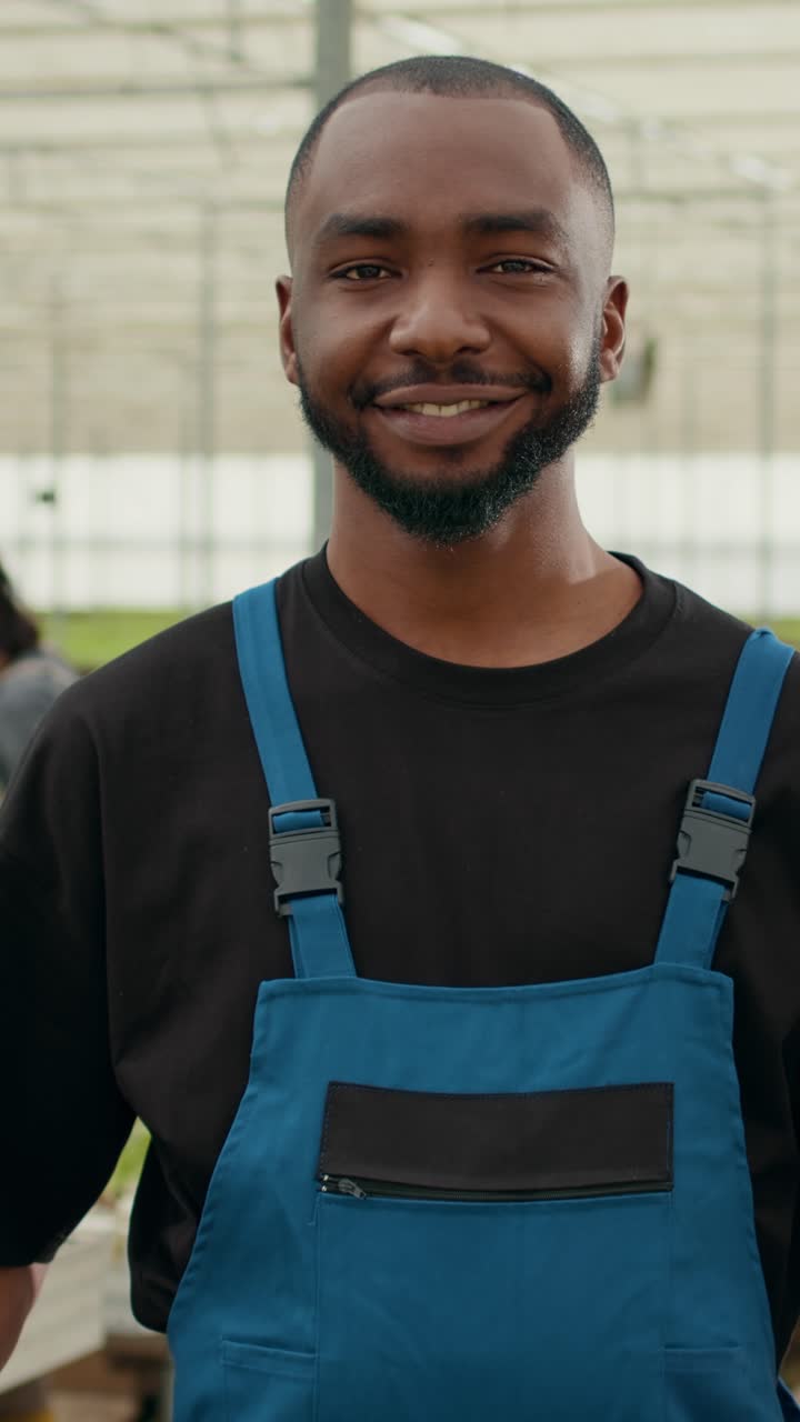 Portrait of african american man holding crate with fresh lettuce production ready for delivery
