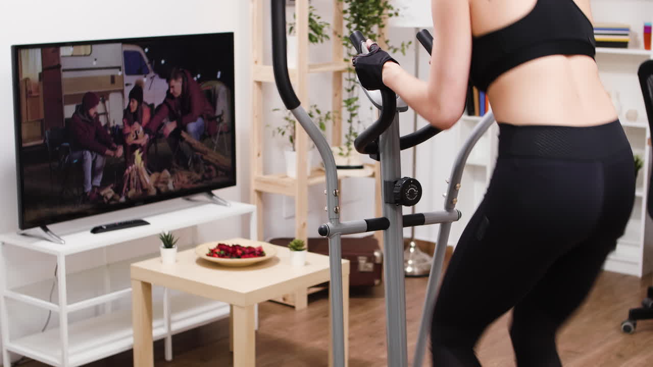 Woman Exercising on Elliptical at Home
