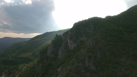 Cliff-of-a-Mountain-With-Forest-Behind-it-Outside-of-Novi-Pazar-in-Serbia-Europe,-Aerial-Forward-Slow