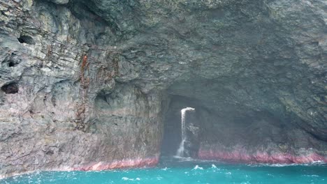 stunning ocean cave with waterfall